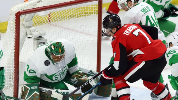 Garret Sparks makes a save as Brady Tkachuk and Morgan Rielly look for a rebound.