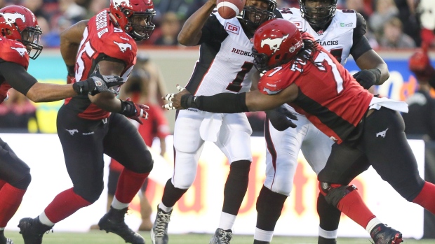 Junior Turner hits Henry Burris., CP Junior Turner hits Henry Burris.