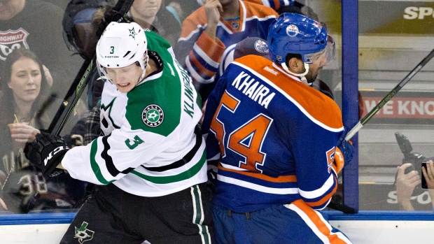 Stars' John Klingberg (3) checks Edmonton Oilers' Jujhar Khaira