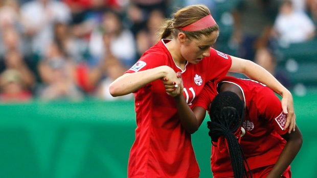 Janine Beckie consoles Kadeisha Buchanan.