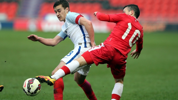 Harry Winks challenged by Marco Bustos