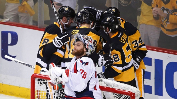 Penguins celebrate behind Holtby, The Canadian Press Penguins celebrate behind Holtby