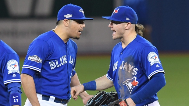 Osuna and Donaldson celebrate, The Canadian Press Osuna and Donaldson celebrate