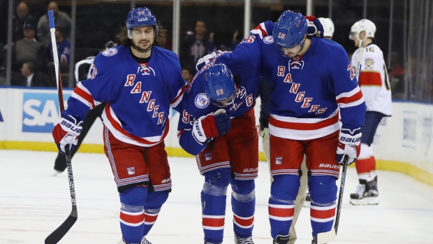 Mika Zibanejad helped off the ice