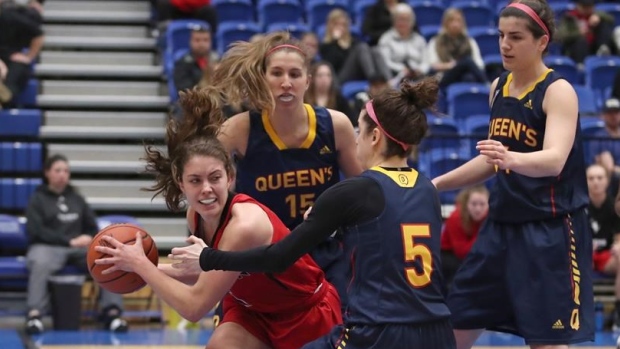 Stephanie Carr surrounded by Queen's Gaels' players