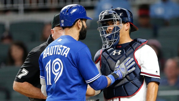 Jose Bautista and Kurt Suzuki, The Canadian Press Jose Bautista and Kurt Suzuki