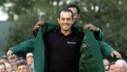Mike Weir gets his green jacket from Tiger Woods