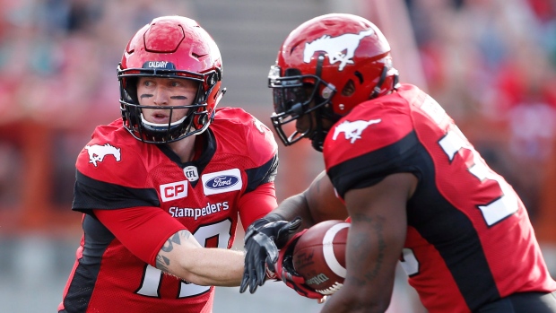 Bo Levi Mitchell hands to Jerome Messam, The Canadian Press Bo Levi Mitchell hands to Jerome Messam