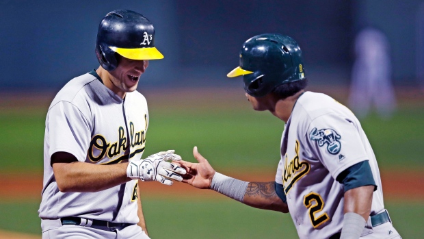 Matt Olson and Khris Davis celebrate, The Canadian Press Matt Olson and Khris Davis celebrate