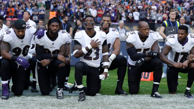 Ravens players kneel during national anthem in London, The Canadian Press Ravens players kneel during national anthem in London