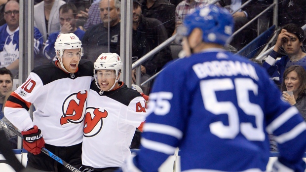 Devils' Jimmy Hayes and Miles Wood (44) celebrate a goal