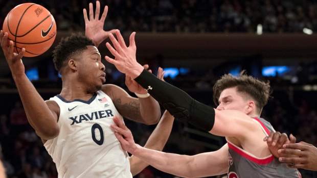 Xavier forward Tyrique Jones (0) and Amar Alibegovic (10)