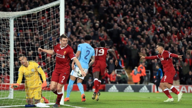 James Milner and Roberto Firmino celebrate in front of Ederson