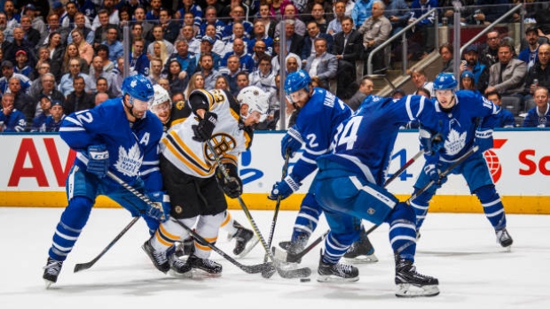 Leafs, Bruins battle for puck, Getty Images Leafs, Bruins battle for puck