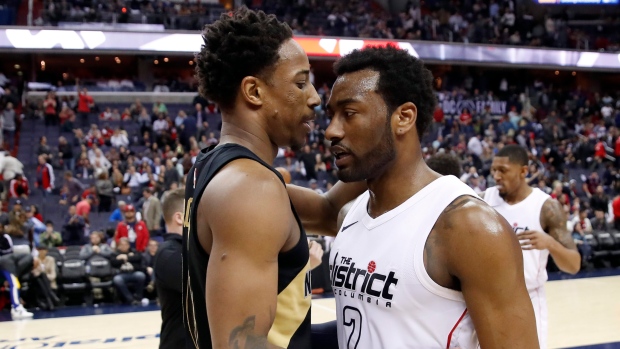 DeMar DeRozan hugs John Wall