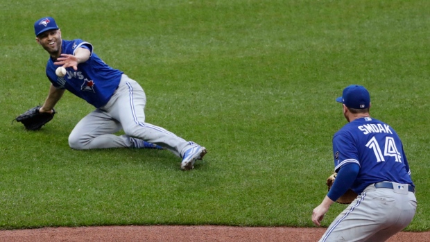 J.A. Happ, Justin Smoak, The Canadian Press J.A. Happ, Justin Smoak