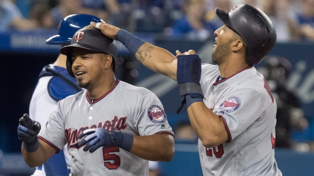 Eduardo Escobar and Eddie Rosario celebrate