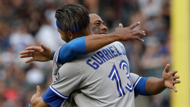  Curtis Granderson, left, hugs Lourdes Gurriel Jr. 