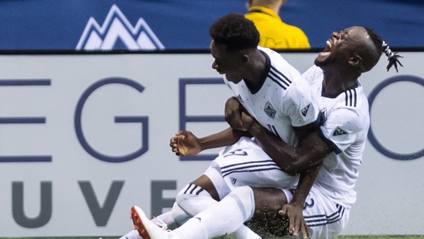 Alphonso Davies and Kei Kamara celebrate