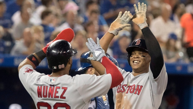 Eduardo Nunez and Rafael Devers celebrate