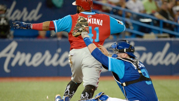 Danny Jansen and Carlos Santana, The Canadian Press Danny Jansen and Carlos Santana