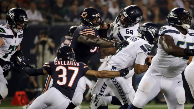 Russell Wilson, Aaron Lynch and Bryce Callahan , The Canadian Press Russell Wilson, Aaron Lynch and Bryce Callahan