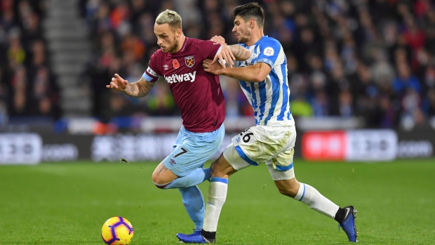 West Ham United's Marko Arnautovic, left, and Huddersfield Town's Christopher Schindler