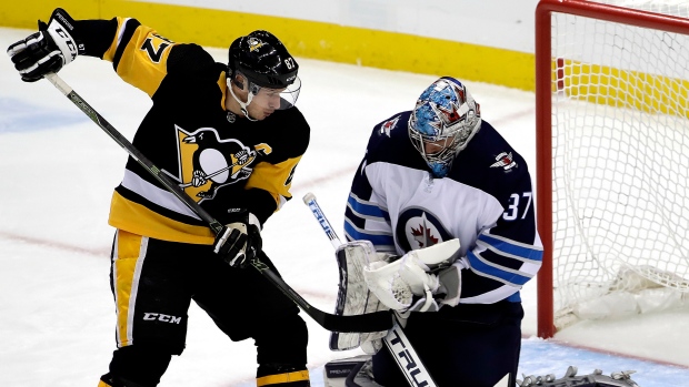 Sidney Crosby Connor Hellebuyck, The Canadian Press Sidney Crosby Connor Hellebuyck