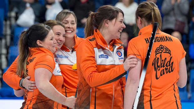 Casey Scheidegger's rink celebrates Friday's wild card game win over Kerri Einarson.