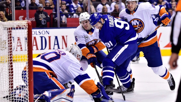 John Tavares battles against the Islanders in Toronto on Dec. 29.
