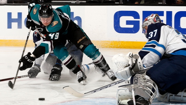 Max Jones and Connor Hellebuyck, Debora Robinson/NHLI via Getty Images Max Jones and Connor Hellebuyck