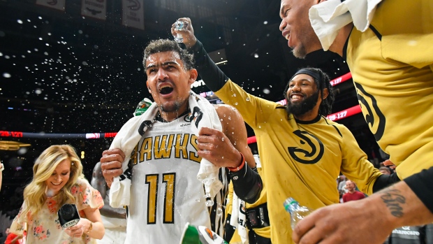  Trae Young has water poured on his head after hitting the game winning shot 