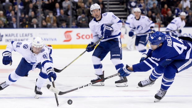 Lightning centre Steven Stamkos and Leafs defenceman Morgan Rielly battle for the puck., The Canadian Press Lightning centre Steven Stamkos and Leafs defenceman Morgan Rielly battle for the puck.