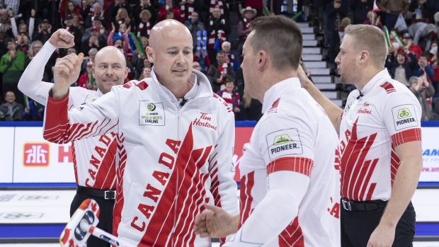 Canada skip Kevin Koe, second left, celebrates his team's victory over Switzerland 