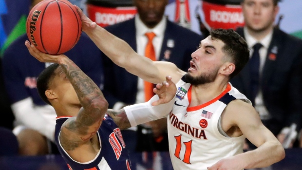 Virginia's Ty Jerome battles Auburn's J'Von McCormick on Saturday.