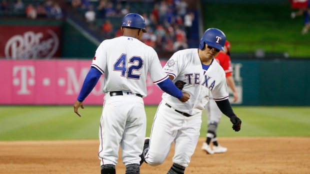 Texas Rangers third base coach Tony Beasley, left, congratulates Shin-Soo Choo