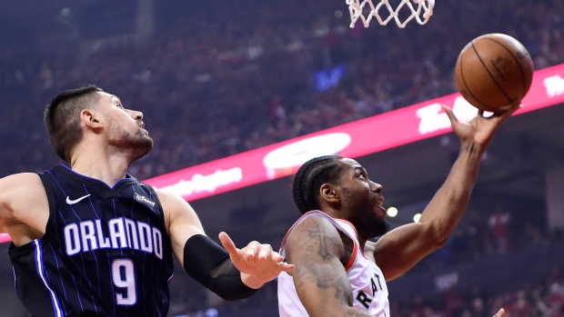 Kawhi Leonard and Orlando Magic centre Nikola Vucevic 