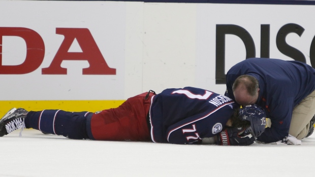 Blue Jacket Josh Anderson is tended to by trainer Mike Vogt.