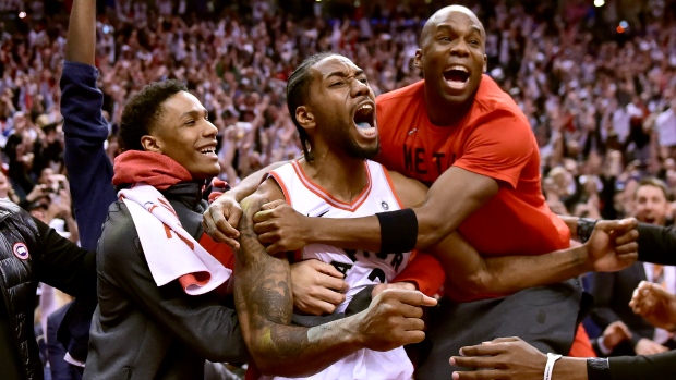 Kawhi Leonard celebrates with teammates 