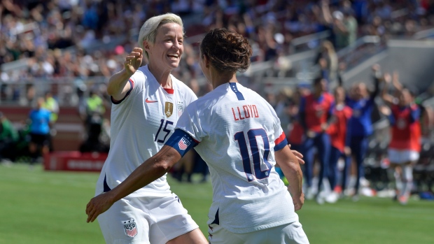 Megan Rapinoe celebrates with forward Carli Lloyd