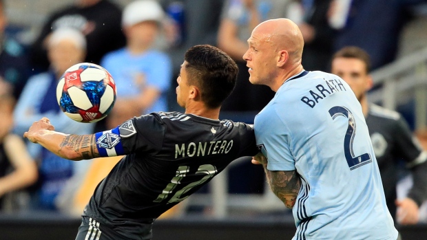 Fredy Montero, left, controls the ball around Sporting Kansas City defender Botond Barath