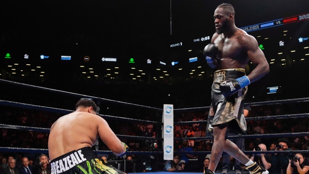 Deontay Wilder, right, knocks down Dominic Breazeale