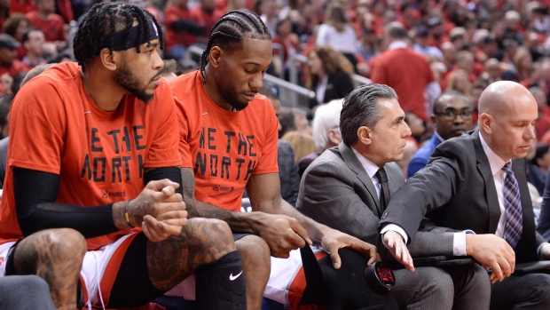 Kawhi Leonard sitting on Raptors' bench