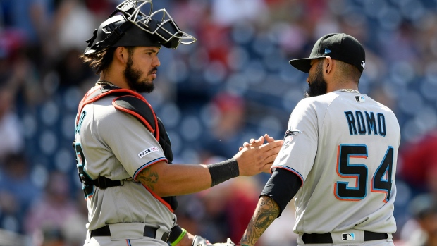 Sergio Romo (54) celebrates with catcher Jorge Alfaro, The Canadian Press Sergio Romo (54) celebrates with catcher Jorge Alfaro