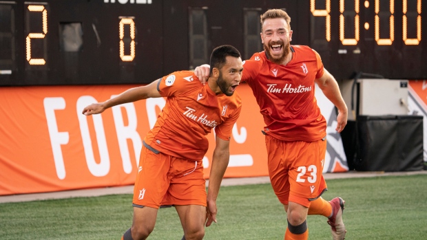  David Choiniere (7) celebrates his game-winning goal with teammate Anthony Novak (23)