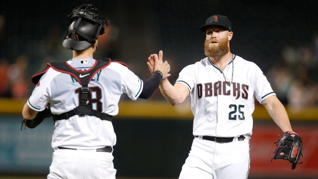 Carson Kelly and Archie Bradley , The Canadian Press Carson Kelly and Archie Bradley