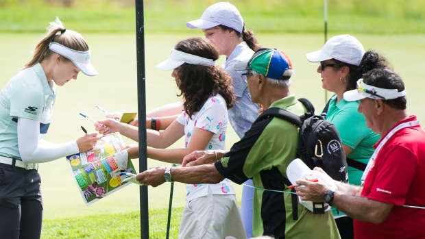 Brooke Henderson signs autographs ahead of Thursday's start of the CP Women's Open.