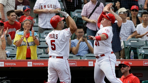 Albert Pujols and Justin Bour, The Canadian Press Albert Pujols and Justin Bour