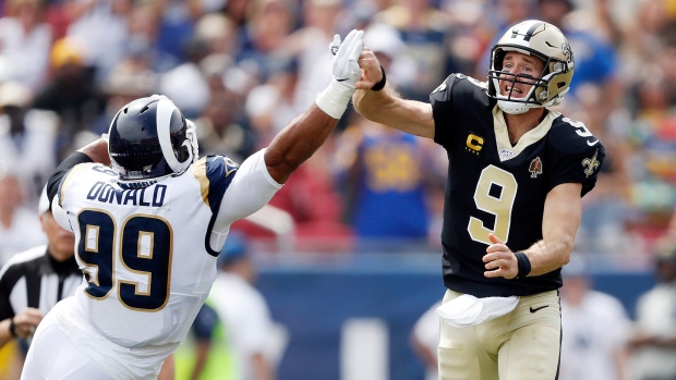 Drew Brees and Aaron Donald, Sean M. Haffey/Getty Images Drew Brees and Aaron Donald