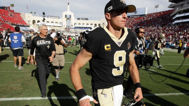 Injured Saints quarterback Drew Brees leaves the field after Sunday's loss to the Rams.